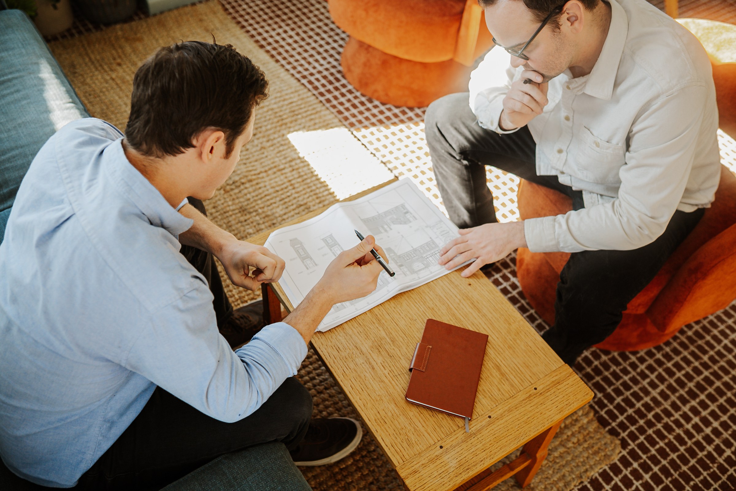 Austin Tunnell and Matt Hayes at a drafting table, working through a project design together.