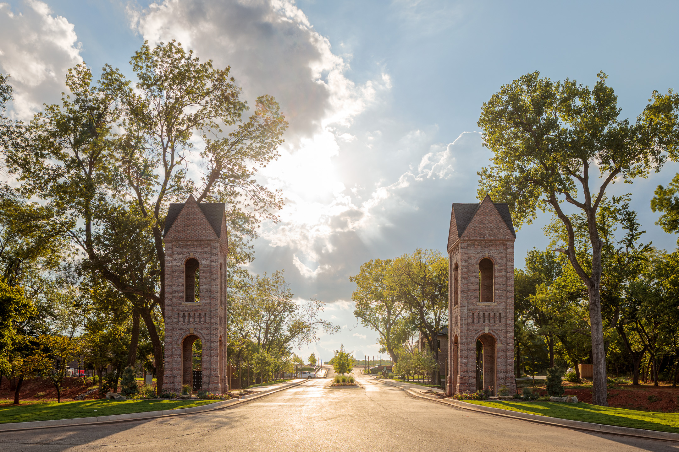 Selah's twin brick masonry towers framing the entrance to the neighborhood at golden hour